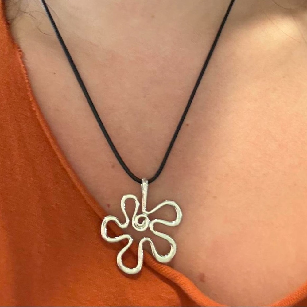 black cord necklace with flower pendant